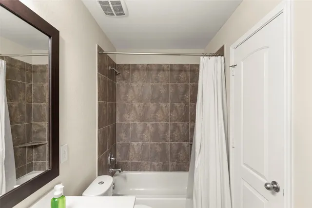 a bathroom with a shower and a bath tub