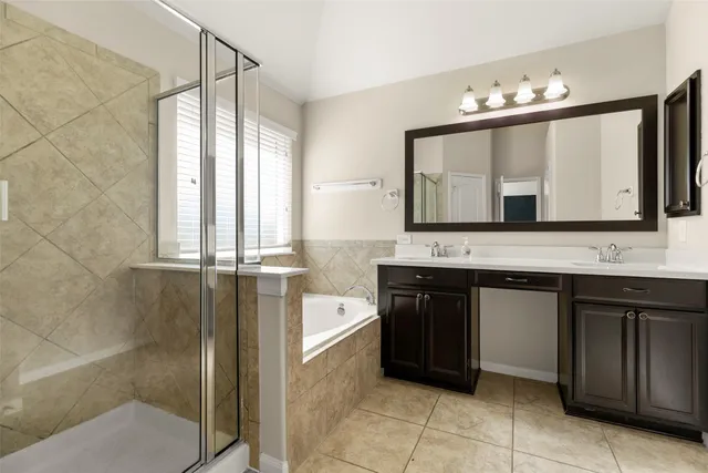 a bathroom with a tub sink and window
