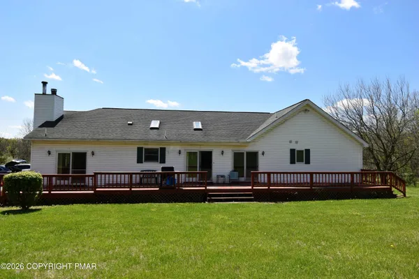 a view of a house with a backyard