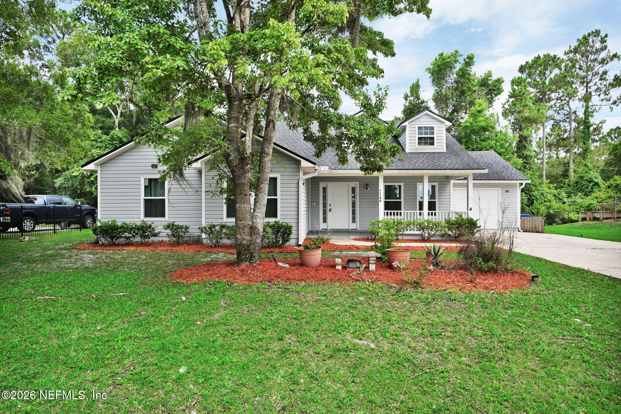 1110 Woodlawn Road, Unit D St. Augustine, FL 32084 - Photo 2 of 40 a front view of house with yard and outdoor seating