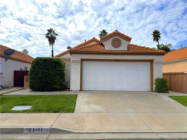 a front view of a house with yard and garage