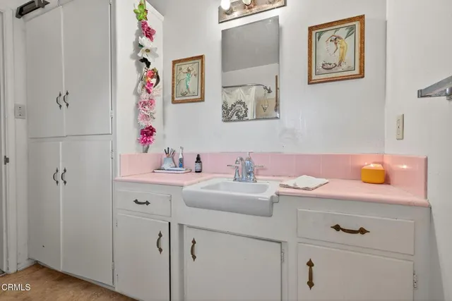 a bathroom with a sink vanity and mirror