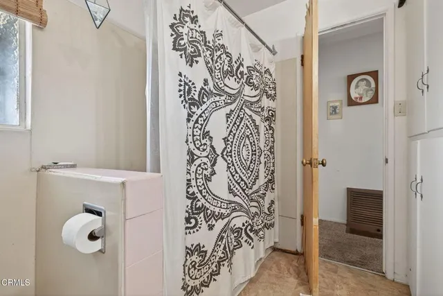 a bathroom with a shower and a mirror