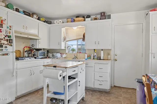 a kitchen with a white cabinets and white appliances
