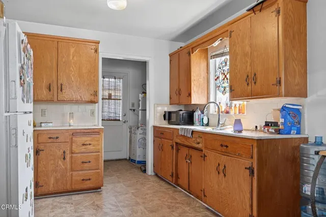 a kitchen with cabinets appliances and a window