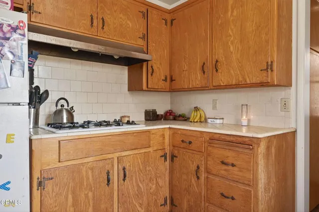 a kitchen with stainless steel appliances granite countertop a sink a stove and cabinets