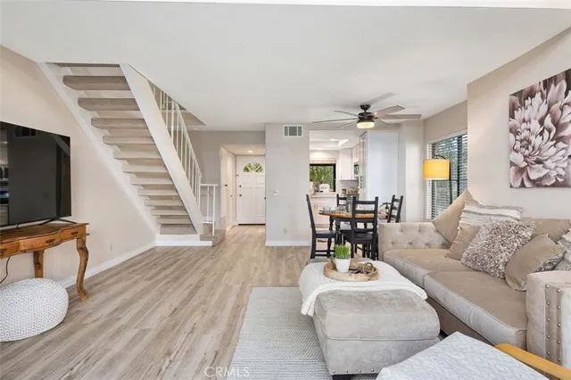 a living room with furniture and wooden floor