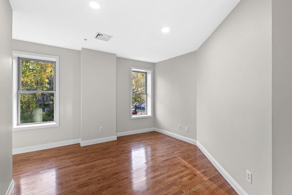 72 River Street, Unit 6 Haverhill, MA 01832 - Photo 31 of 40 an empty room with wooden floor and windows