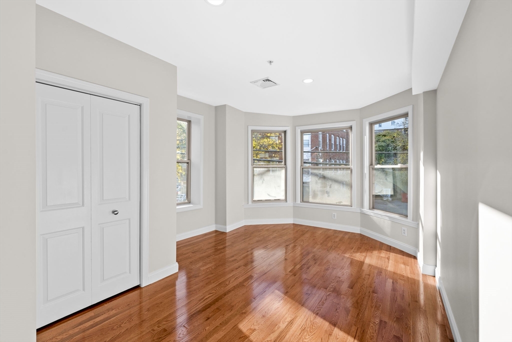 72 River Street, Unit 6 Haverhill, MA 01832 - Photo 35 of 40 a view of an empty room with wooden floor and a window
