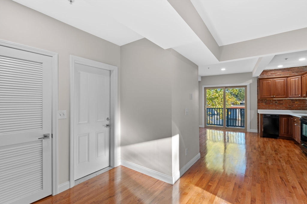 72 River Street, Unit 6 Haverhill, MA 01832 - Photo 7 of 40 a view of a big room with wooden floor fireplace and windows