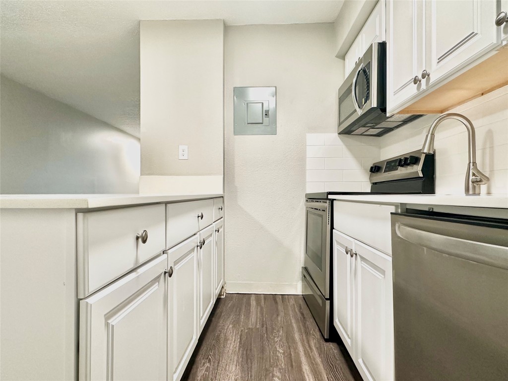 1200 Banister Lane, Unit 4 Austin, TX 78704 - Photo 11 of 15 a kitchen with cabinets and wooden floor