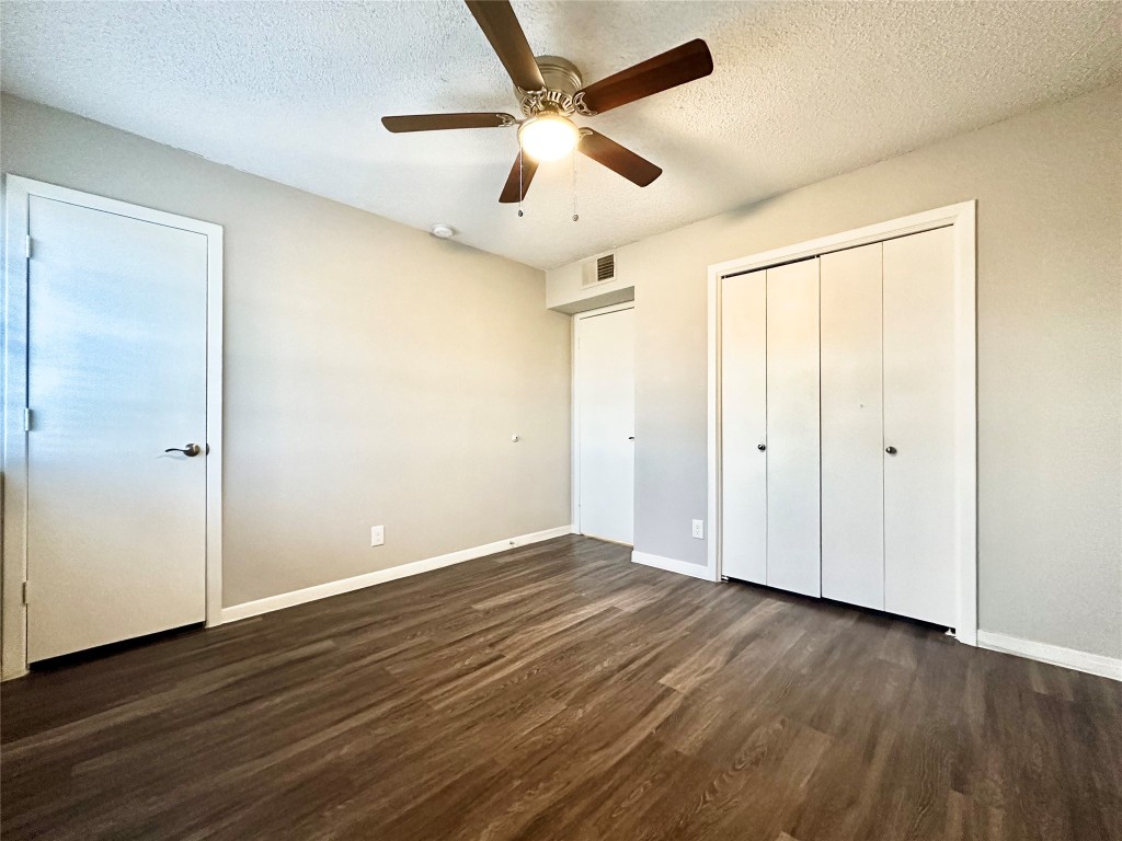 1200 Banister Lane, Unit 4 Austin, TX 78704 - Photo 12 of 15 a view of an empty room with wooden floor