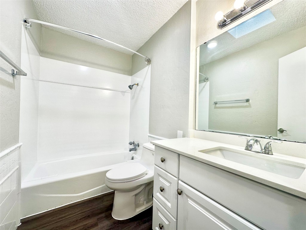 1200 Banister Lane, Unit 4 Austin, TX 78704 - Photo 14 of 15 a bathroom with a sink a toilet and a bathtub