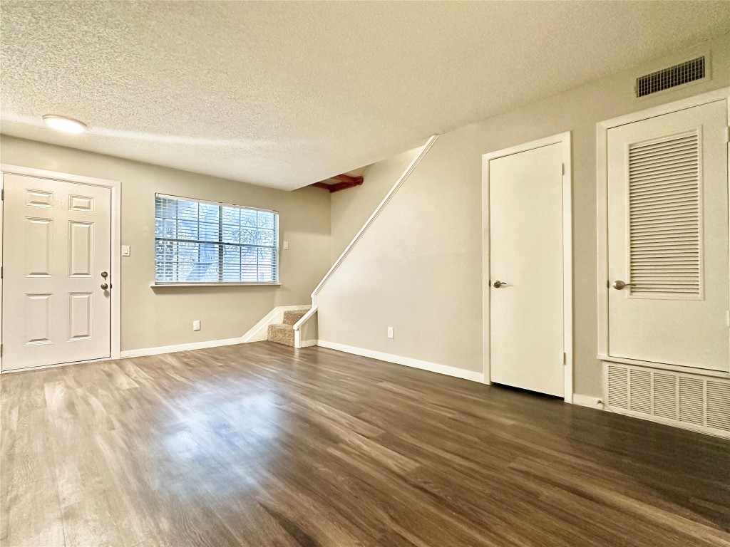 1200 Banister Lane, Unit 4 Austin, TX 78704 - Photo 7 of 15 an empty room with wooden floor and windows