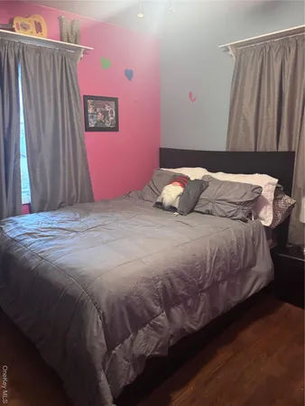 a bedroom with a bed and a mirror