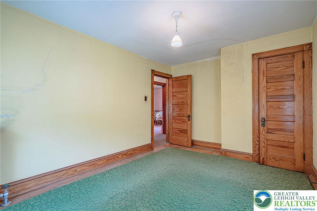 159 West Ridge Street Nesquehoning, PA 18240 - Photo 21 of 55 A quaint room featuring durable carpet flooring and traditional wooden doors.