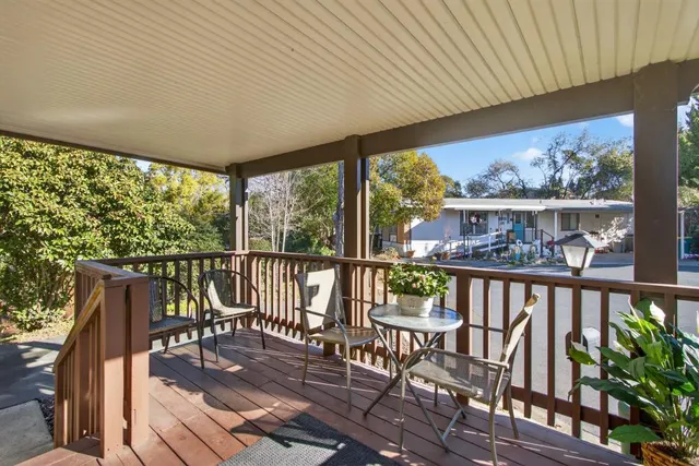 a view of a chairs and table in the balcony