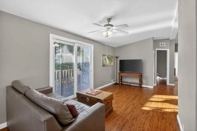 a living room with furniture and a floor to ceiling window