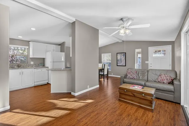 a bathroom with a granite countertop sink a mirror and a shower
