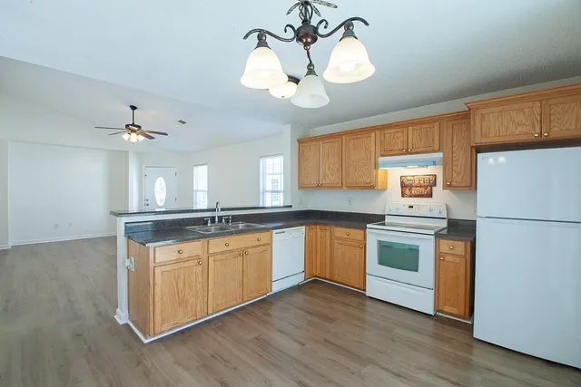 a view of a kitchen with electric appliances and cabinets