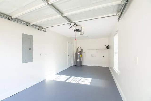 a view of hallway with a large window and chandelier fan