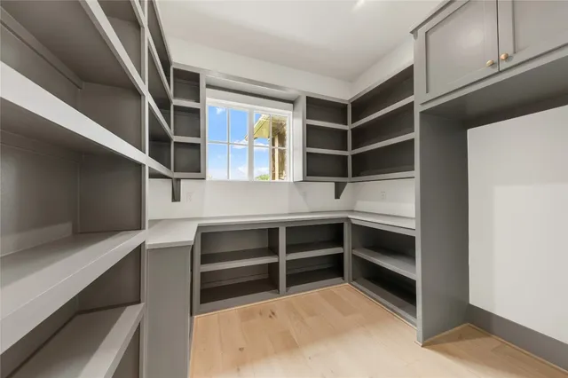 an empty room with window and ceiling fan