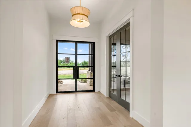 a view of an empty room with a window and fireplace