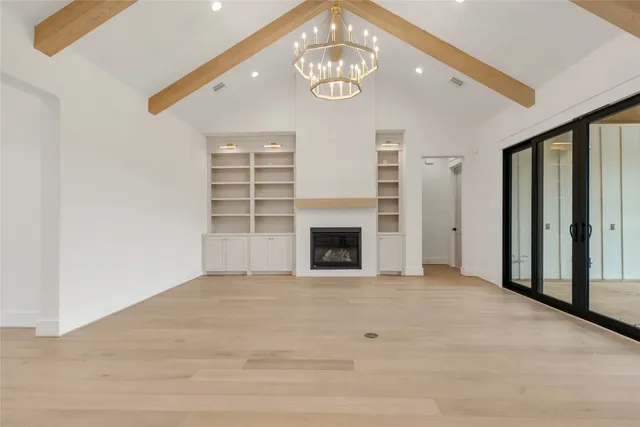 a large kitchen with stainless steel appliances kitchen island granite countertop a refrigerator and a sink