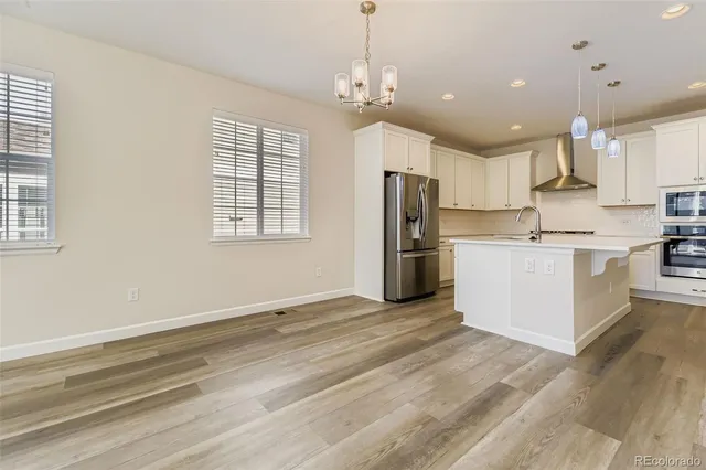 an empty room with closet and windows