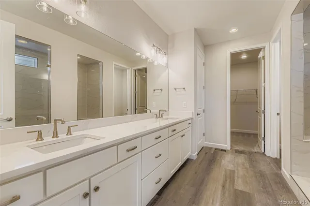 an empty room with chandelier fan and windows