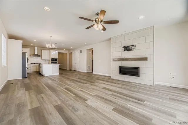 a kitchen with stainless steel appliances kitchen island granite countertop a refrigerator and cabinets