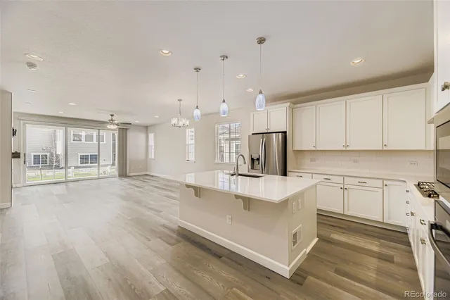 a kitchen with a sink stove and refrigerator