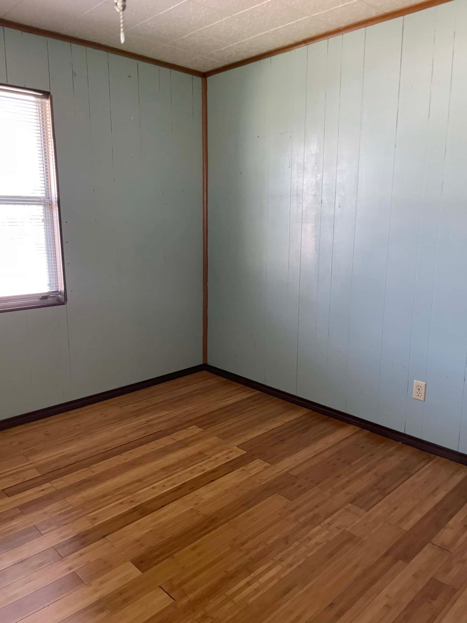 1825 Isom Street Houston, TX 77039 - Photo 19 of 27 an empty room with wooden floor and windows in it