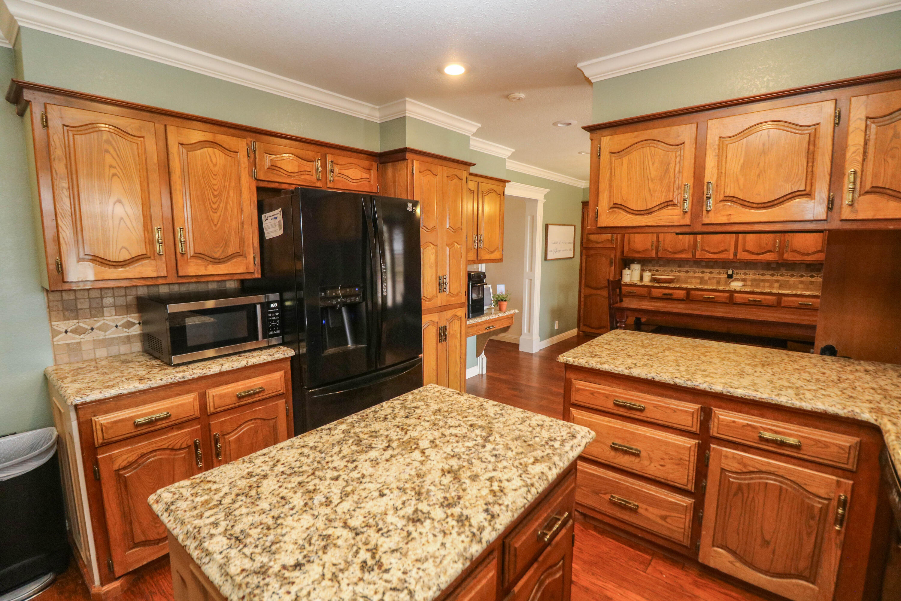 1740 Highway 70 Springlake, TX 79082 - Photo 8 of 39 a kitchen with stainless steel appliances granite countertop a refrigerator stove top oven dining table and chairs