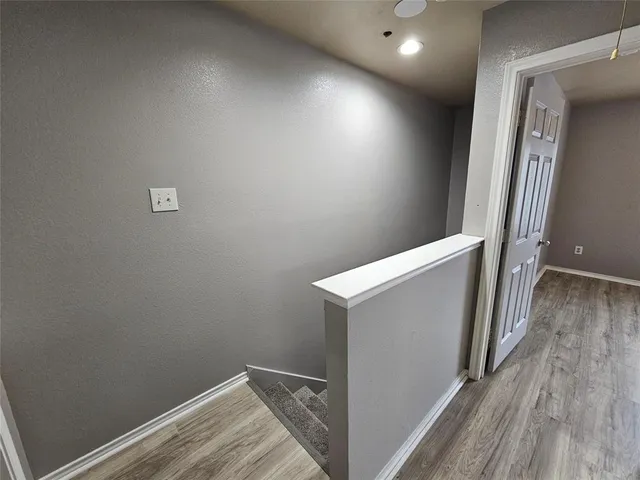 a view of hallway with wooden floor