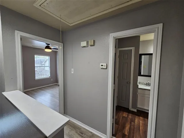 a hallway with sliding door and wooden floor