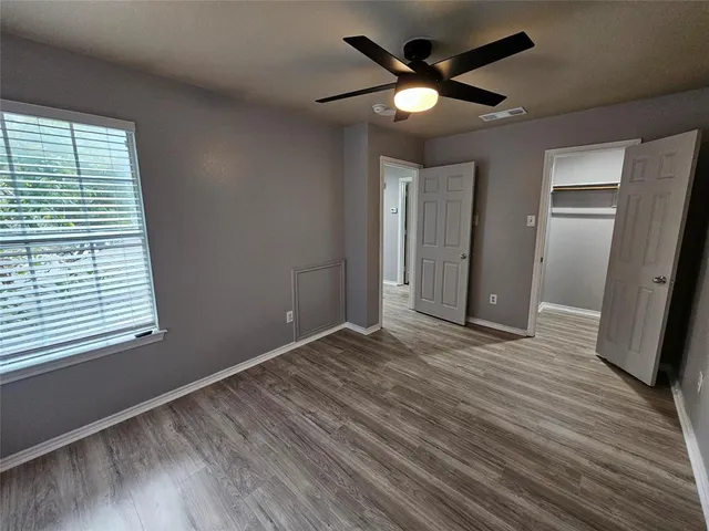 a bathroom with a granite countertop sink double vanity and a mirror