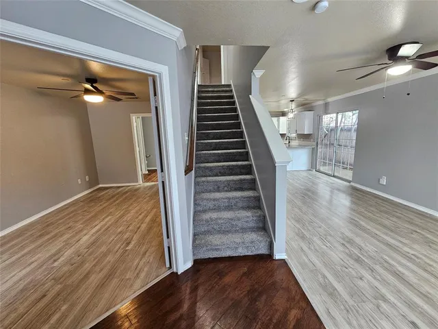 a view of a hallway view with wooden floor and staircase