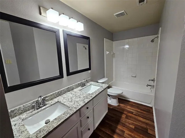 a bathroom with a toilet and a bathtub