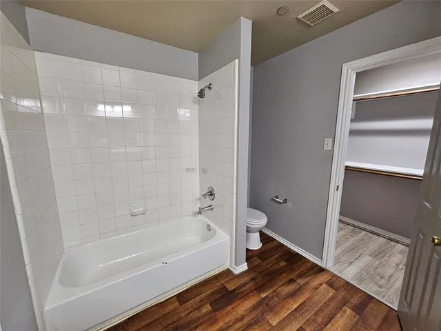 a bathroom with a bathtub and shower