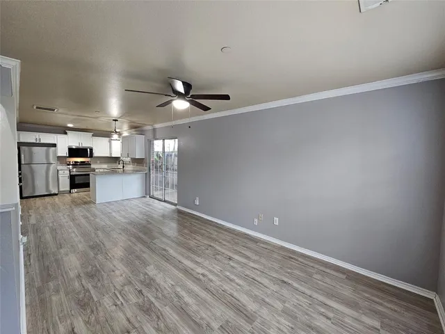 a view of a kitchen with a stove cabinets and wooden floor