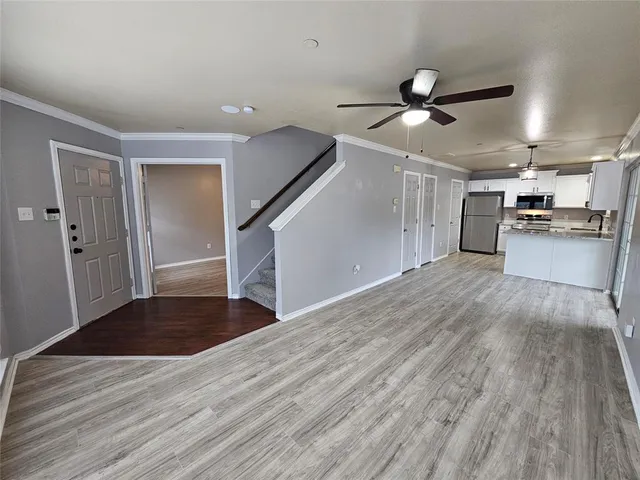 a view of a kitchen with a sink and a refrigerator