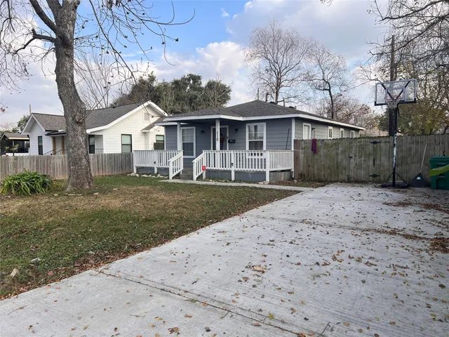 a front view of a house with a yard and trees