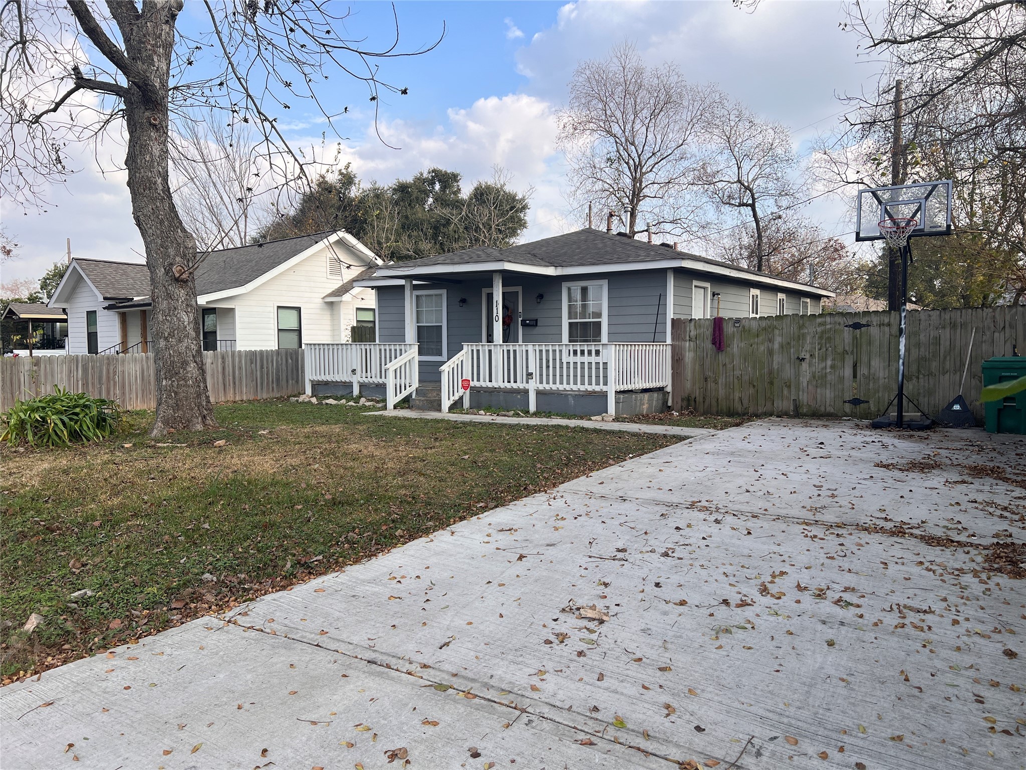 a front view of a house with a yard and trees