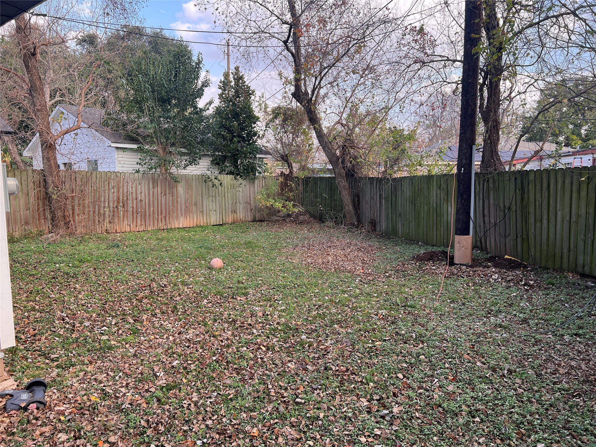 110 Gans Street Houston, TX 77029 - Photo 17 of 17 a view of a backyard with large trees and wooden fence