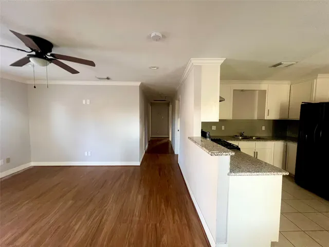 a view of a kitchen cabinets a sink and wooden floor