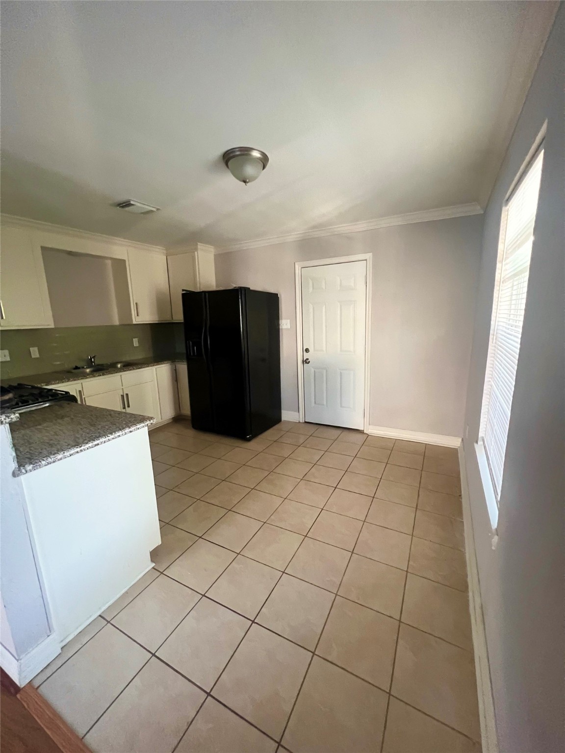 110 Gans Street Houston, TX 77029 - Photo 8 of 17 a view of kitchen with cabinets and refrigerator