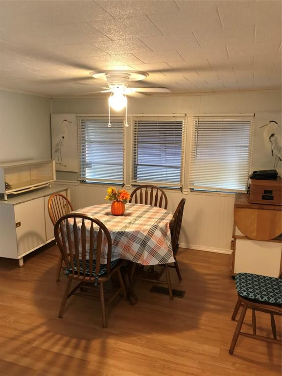 1112 Southeast 21st Street Okeechobee, FL 34974 - Photo 12 of 20 a bedroom with a bed and a dresser in it