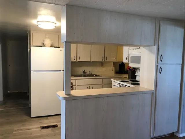 a kitchen with a refrigerator a stove a microwave and cabinets