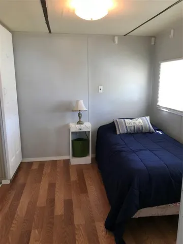 a bedroom with a bed and window